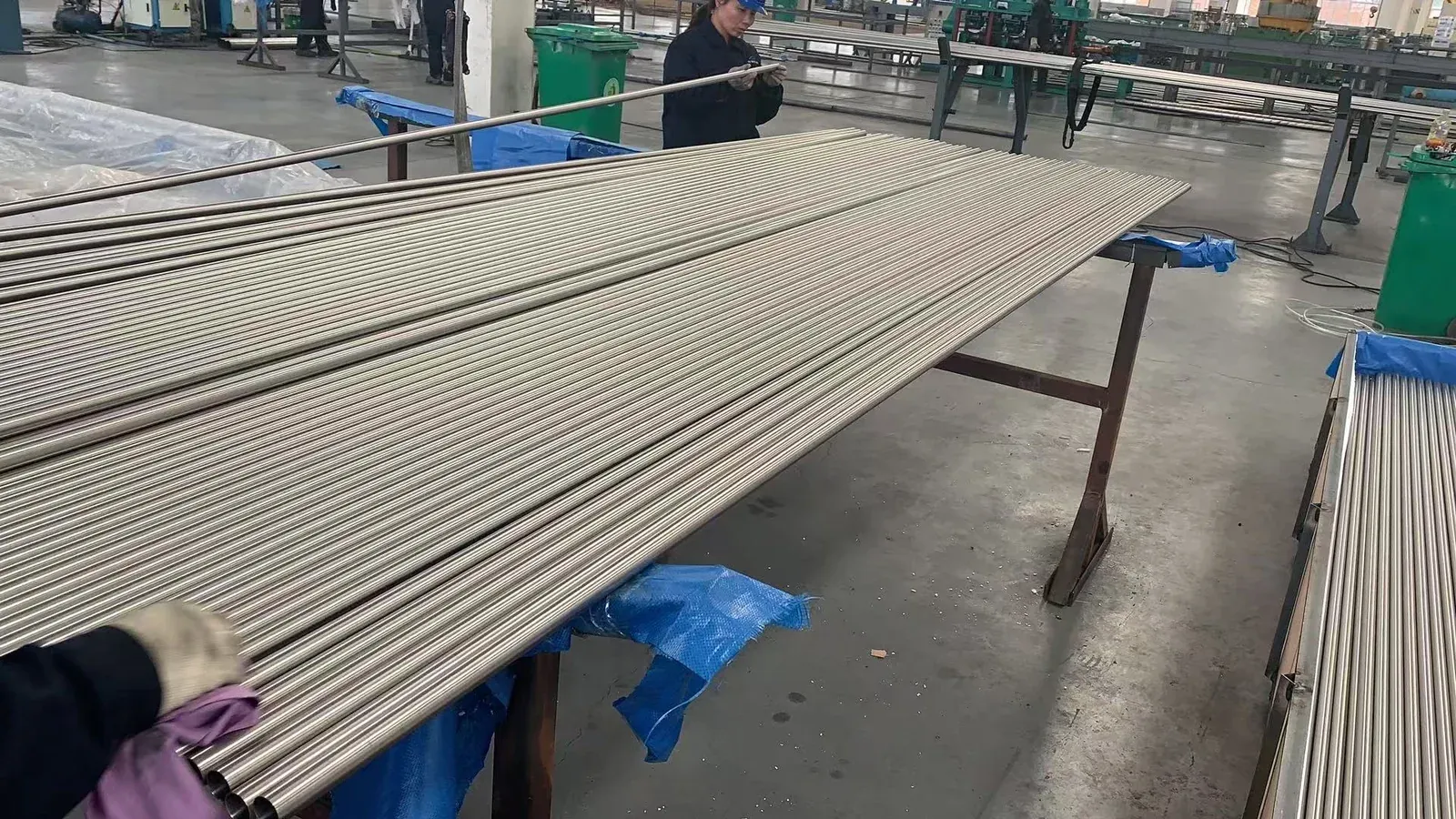 An operator checking a titanium tube at a qualified manufacturing partner facility.